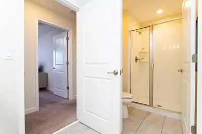 a bathroom with a toilet and a walk in shower at Four Bedrooms TownHome 4861 in Kissimmee