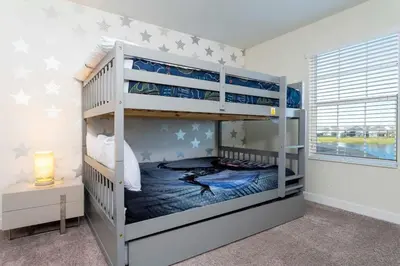 a bedroom with two bunk beds and a window at Four Bedrooms TownHome 4861 in Kissimmee