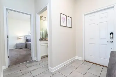 a hallway with a white door and a mirror at Four Bedrooms TownHome 4861 in Kissimmee