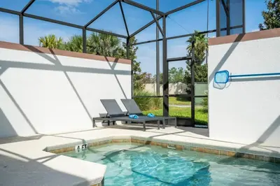 a swimming pool with a table and chairs in a building at Five Bedrooms TownHome with Pool 4849 in Kissimmee