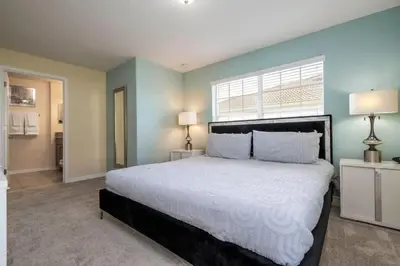 a bedroom with a large bed and a window at Five Bedrooms TownHome with Pool 4849 in Kissimmee