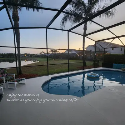 a large swimming pool with a sign saying enjoy the warming sometimes as you enjoy your at Lake Berkley Home #213517 in Kissimmee