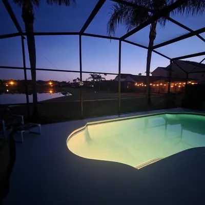 an empty swimming pool at night with a view at Lake Berkley Home #213517 in Kissimmee