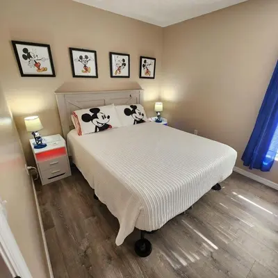 a bedroom with a bed with black and white pillows at Lake Berkley Home #213517 in Kissimmee