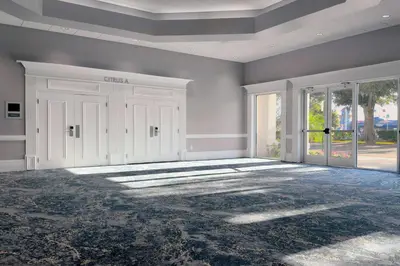 an empty room with white doors and a large window at Wyndham I-Drive Avanti Resort & Conference Center in Orlando