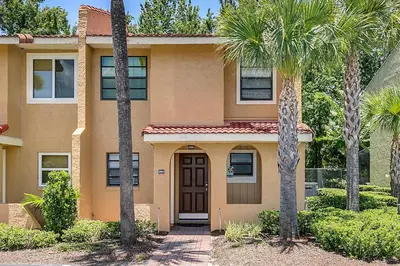 a house with palm trees in front of it at Family Vacation Villa, Water Park, Endless Amenities in Kissimmee
