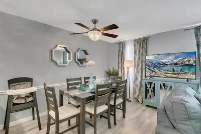 a dining room with a table with chairs and a ceiling fan at Family Vacation Villa, Water Park, Endless Amenities in Kissimmee