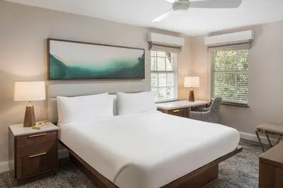 a bedroom with a large bed and a flat screen tv at Marriott's Lakeshore Reserve in Orlando