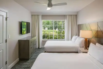 a hotel room with two beds and a window at Marriott's Lakeshore Reserve in Orlando