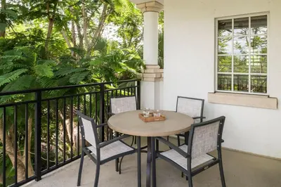 a wooden table and chairs on a balcony at Marriott's Lakeshore Reserve in Orlando