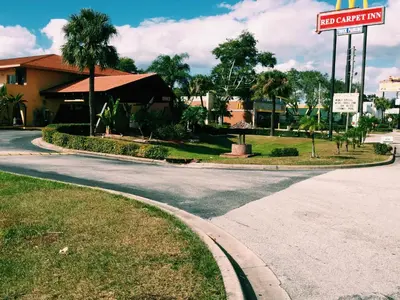 an empty street with a no parking sign and a motel at The keys in Kissimmee