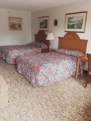 a hotel room with two beds and a desk at The keys in Kissimmee