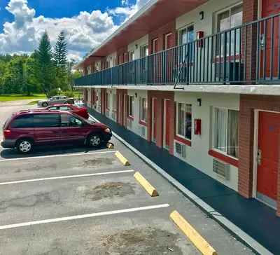 a car parked in a parking lot in front of a motel at The keys in Kissimmee