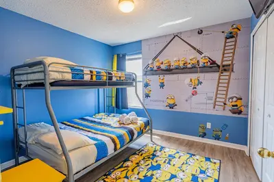 a bedroom with a bunk bed with a blue wall at 5-Star Resort Villa with Private Pool, Minutes from Disney in Kissimmee