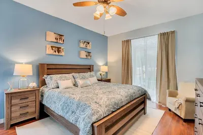 a bedroom with a bed and a ceiling fan at 5-Star Resort Villa with Private Pool, Minutes from Disney in Kissimmee