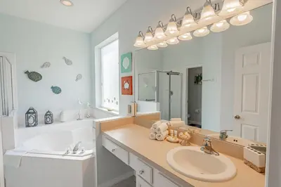 a bathroom with a sink and a large mirror at 5-Star Resort Villa with Private Pool, Minutes from Disney in Kissimmee