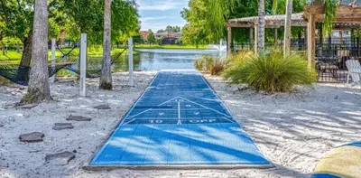 a blue paddle board in a park with a pond at 5-Star Resort Villa with Private Pool, Minutes from Disney in Kissimmee