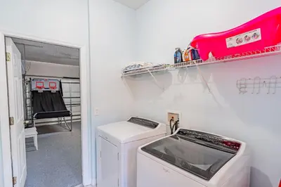 a laundry room with a washer and dryer in it at 5-Star Resort Villa with Private Pool, Minutes from Disney in Kissimmee