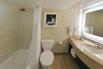 a bathroom with a toilet and a tub and a sink at Hilton Orlando/Altamonte Springs in Orlando