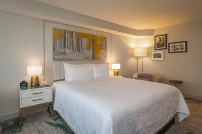 a bedroom with a large white bed and two lamps at Castle Hotel, Autograph Collection in Orlando