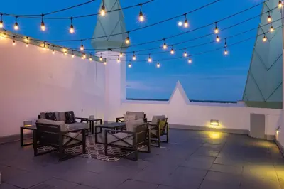 a patio with a table and chairs and lights at Castle Hotel, Autograph Collection in Orlando