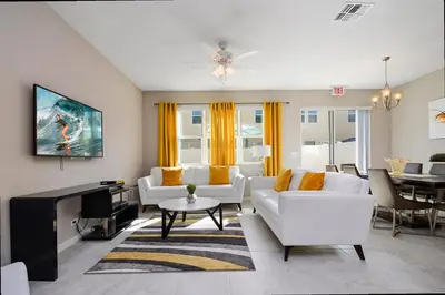 a living room with a white couch and a table at Four Bedrooms TownHome 5122 in Kissimmee