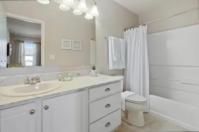 a white bathroom with a sink and a toilet at Four Bedrooms TownHome 5122 in Kissimmee