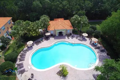 an overhead view of a swimming pool in front of a house at Four Bedrooms TownHome 5122 in Kissimmee