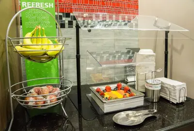 a counter top with a bunch of fruit in baskets at Hampton Inn & Suites Orlando-John Young Parkway/South Park in Orlando