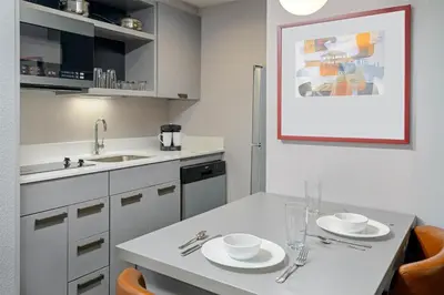 a kitchen with a table with two plates on it at Homewood Suites by Hilton Orlando-UCF Area in Orlando