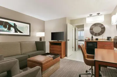a living room with a couch and a dining room at Embassy Suites by Hilton Orlando International Drive ICON Park in Orlando