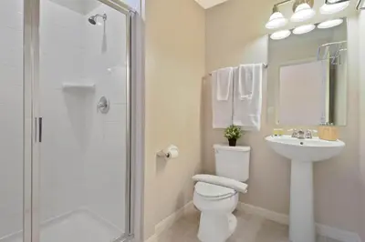 a bathroom with a toilet and a sink and a shower at Four Bedrooms TownHome 5130 in Kissimmee