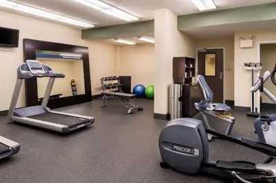 a gym with treadmills and machines in a room at Hampton Inn & Suites Orlando-East UCF in Orlando