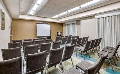 a conference room with chairs and a whiteboard at Hampton Inn & Suites Orlando-East UCF in Orlando