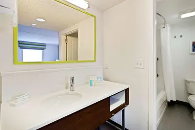 a bathroom with a sink and a mirror at Hampton Inn & Suites Orlando International Drive North in Orlando