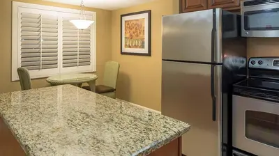 a kitchen with a refrigerator and a counter top at Bluegreen Vacations Orlando's Sunshine Resort in Orlando