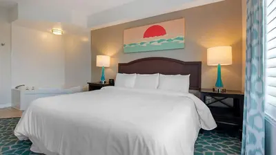 a bedroom with a large white bed with two lamps at Bluegreen Vacations Orlando's Sunshine Resort in Orlando