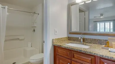 a bathroom with a sink and a toilet and a mirror at Bluegreen Vacations Orlando's Sunshine Resort in Orlando