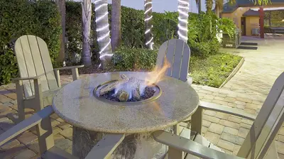 a fire pit on a table with two chairs at Bluegreen Vacations Orlando's Sunshine Resort in Orlando