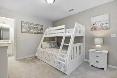 a bedroom with a white bunk bed with a ladder at Four Bedrooms Resort TownHome 5128 in Kissimmee