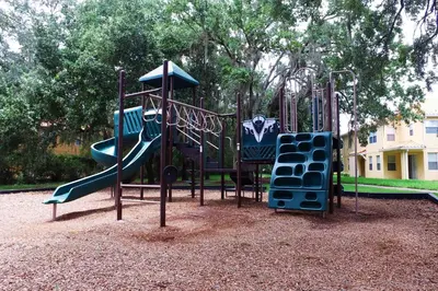 a playground with a slide in a park at Four Bedrooms Resort TownHome 5128 in Kissimmee