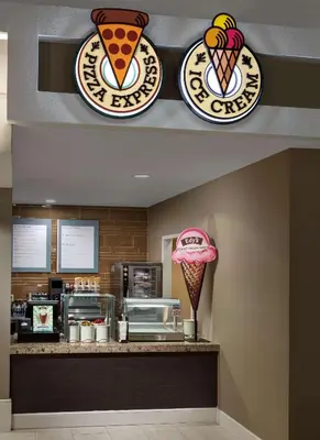 a restaurant with ice cream signs on a counter at Embassy Suites by Hilton Orlando Lake Buena Vista Resort in Orlando
