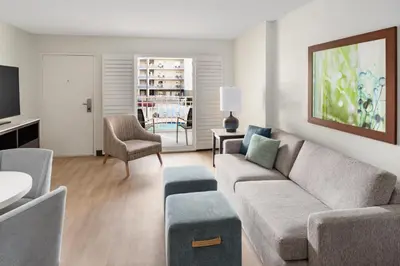 a living room with a couch and a table at Embassy Suites by Hilton Orlando Lake Buena Vista Resort in Orlando