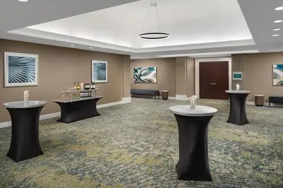 a large room with tables and chairs in it at Embassy Suites by Hilton Orlando Lake Buena Vista Resort in Orlando