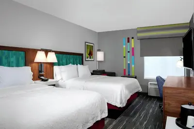 a hotel room with two beds and a television at Hampton Inn Lake Buena Vista / Orlando in Orlando