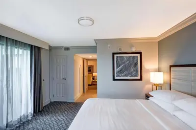 a hotel room with a large bed and a window at Embassy Suites by Hilton Orlando Downtown in Orlando