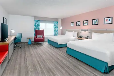 a hotel room with two beds and a flat screen tv at Hilton Garden Inn Orlando International Drive North in Orlando