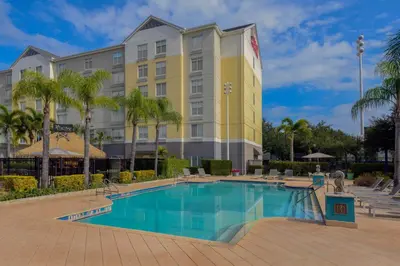 a hotel with a swimming pool in front of a building at Hilton Garden Inn Orlando International Drive North in Orlando