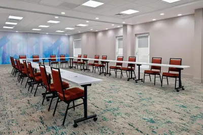 a conference room with a long table and chairs at Hilton Garden Inn Orlando International Drive North in Orlando
