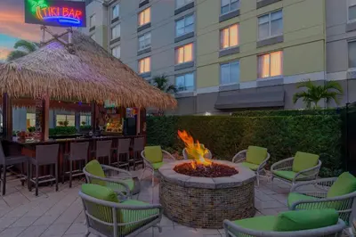 a fire pit in a patio with chairs and a bar at Hilton Garden Inn Orlando International Drive North in Orlando